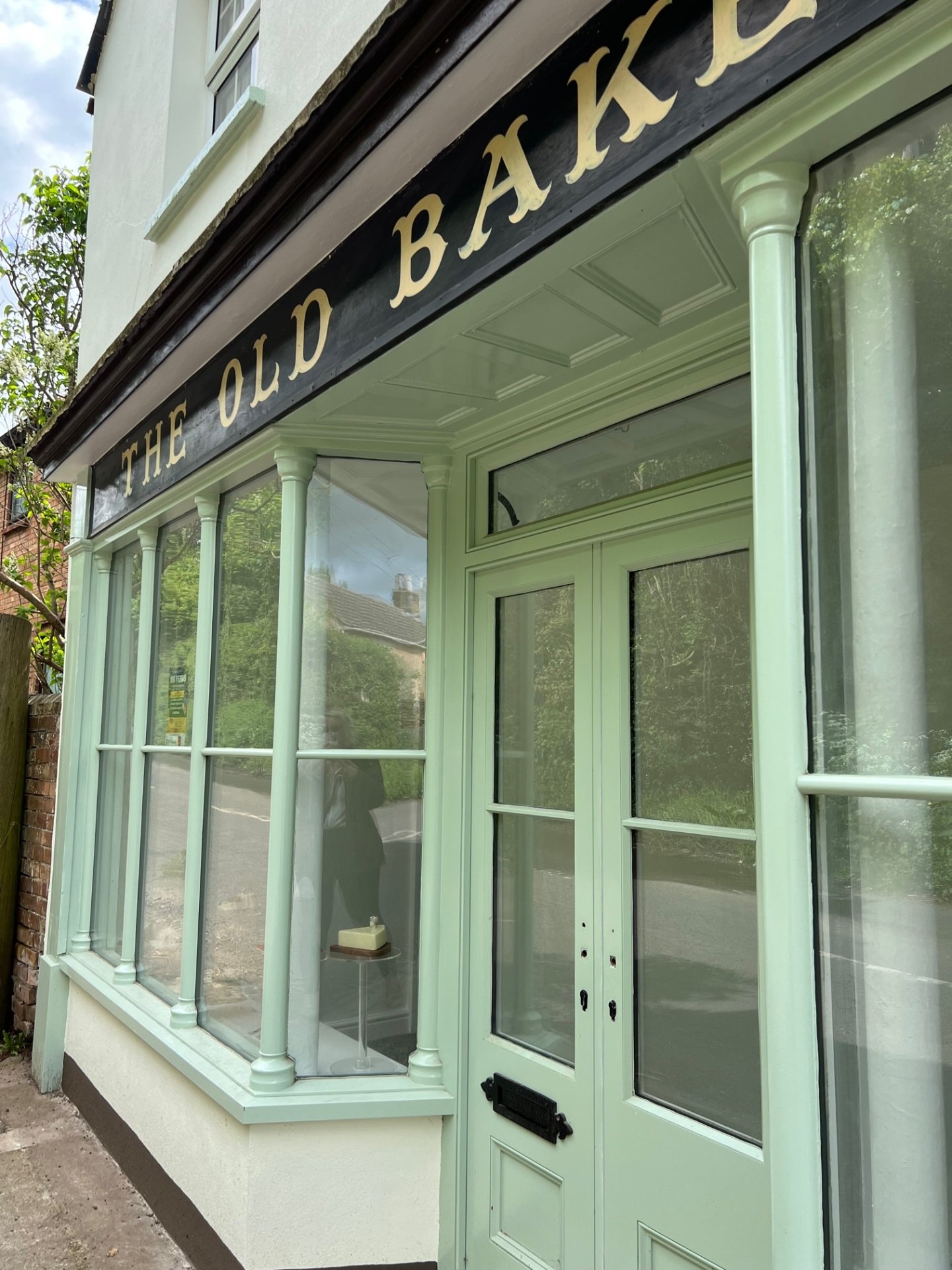 The restored shopfront corner with a bespoke curved timber pillar & glazed timber door