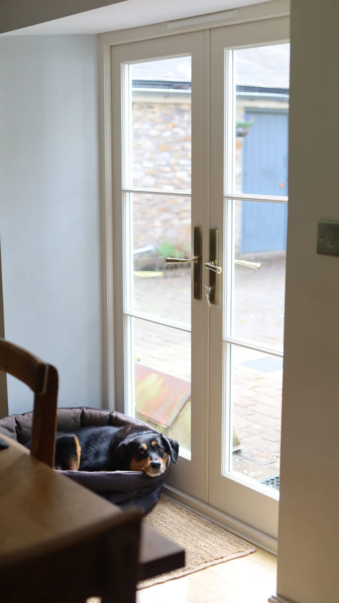 Interior view of bespoke timber French doors with brass handles at Widcombe Grange